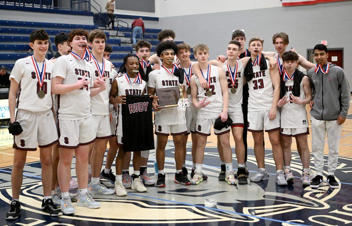 State College boys basketball celebrates the District 6 6A championship win over Altoona at Mount Aloysius College on Friday, Feb. 24, 2023.