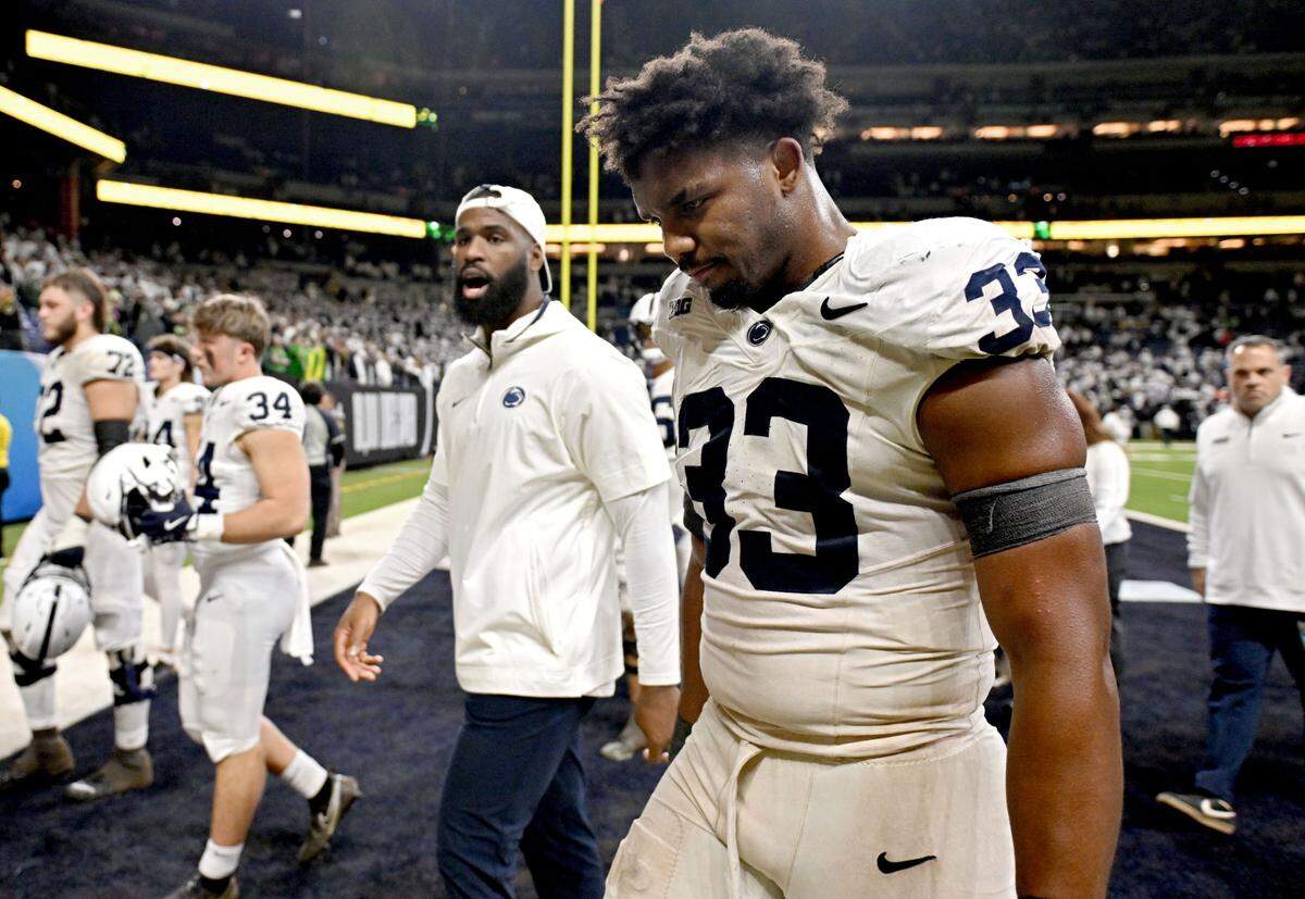 Penn state defensive end Dani Dennis-Sutton walks off the field in disappointment after falling to Oregon in the Big Ten Championship game at Lucas Oil Stadium on Saturday, Dec. 7, 2024.