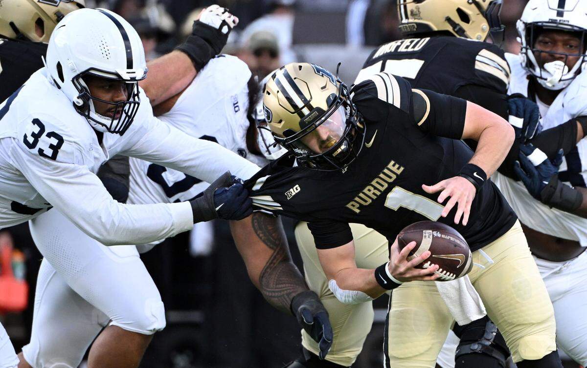 Nov 16, 2024; West Lafayette, Indiana, USA; Purdue Boilermakers quarterback Hudson Card (1) is sacked by Penn State Nittany Lions defensive end Dani Dennis-Sutton (33) during the first quarter at Ross-Ade Stadium. Mandatory Credit: Marc Lebryk-Imagn Images