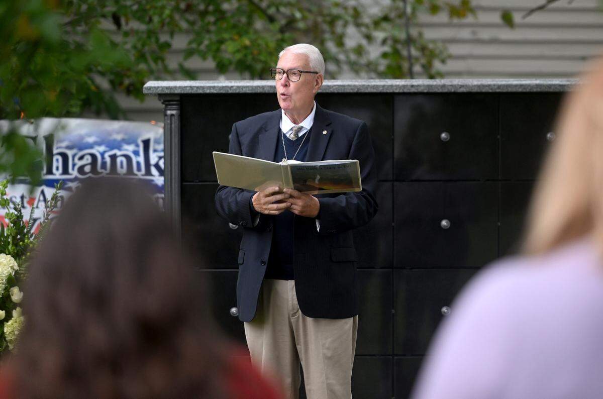 Pastor Spencer Garvin gives a committal Wednedsday for the unclaimed remains placed in the new columbarium at the Union Cemetery in Bellefonte.