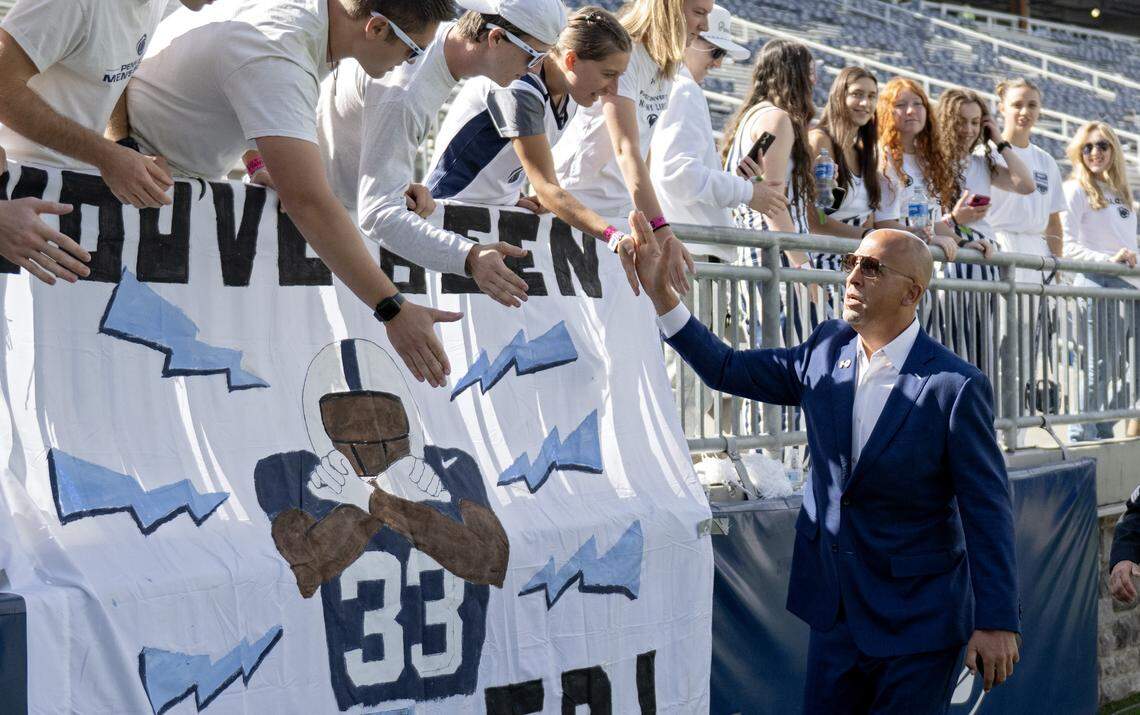 Penn State football coach James Franklin high-fives fans in the student section before the homecoming game against Northwestern on Saturday, Oct. 11, 2025.
