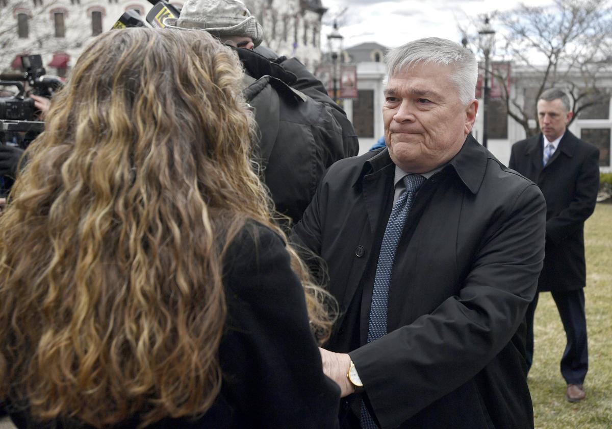 Penn State president Eric Barron shakes hands with Evelyn Piazza after the anti-hazing legislation named after Timothy Piazza was introduced outside of the Centre County Courthouse on March 23, 2018.