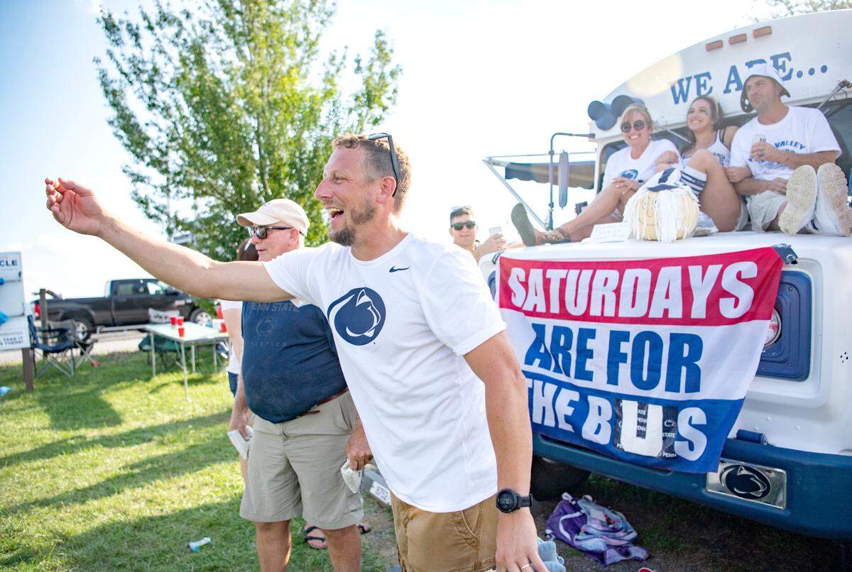 Dominic Pelegrino plays bean bag toss with his friends outside of Beaver Stadium.