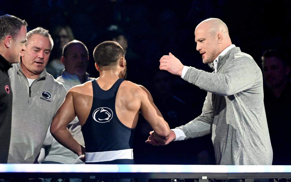 Penn State wrestling coach Cael Sanderson congratulates Shayne Van Ness after his win during the dual against Iowa on Friday, Jan. 31, 2025 at the Bryce Jordan Center.