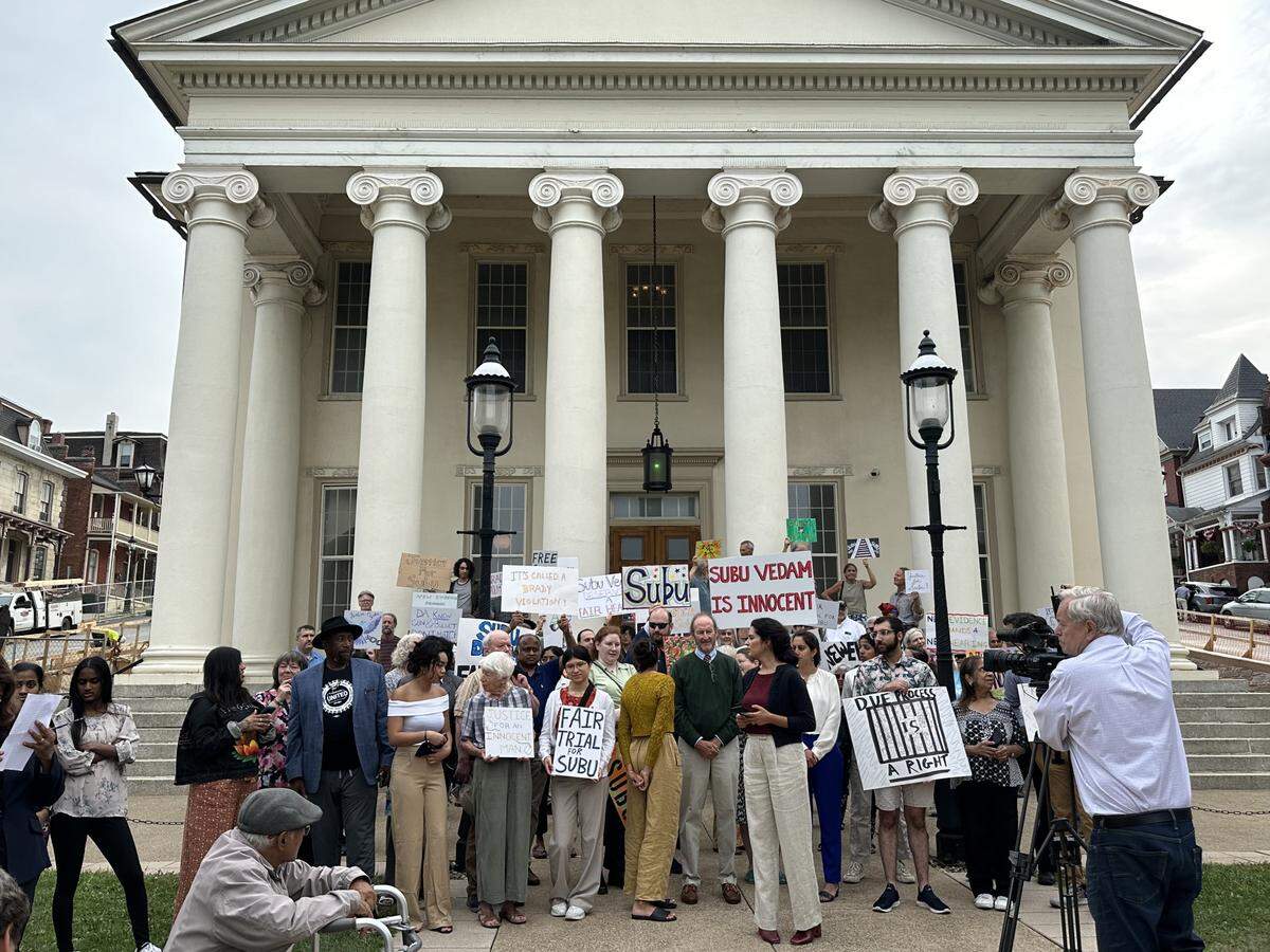 Supporters of Subramanyam Vedam hold up signs outside the Centre County Courthouse on Monday, July 22, 2024.