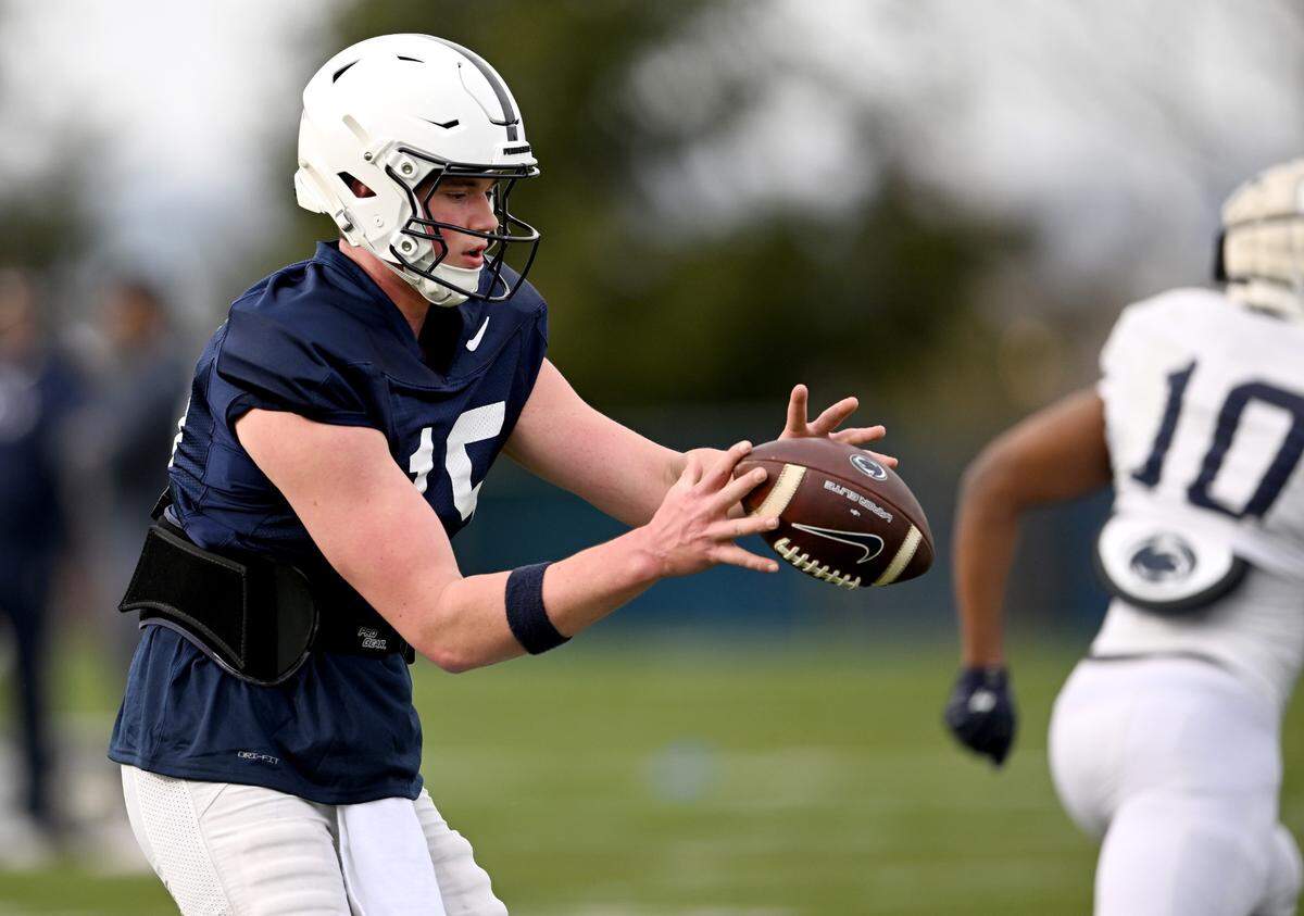 Penn State quarterback Drew Allar runs a play during practice on Tuesday, April 11, 2023.