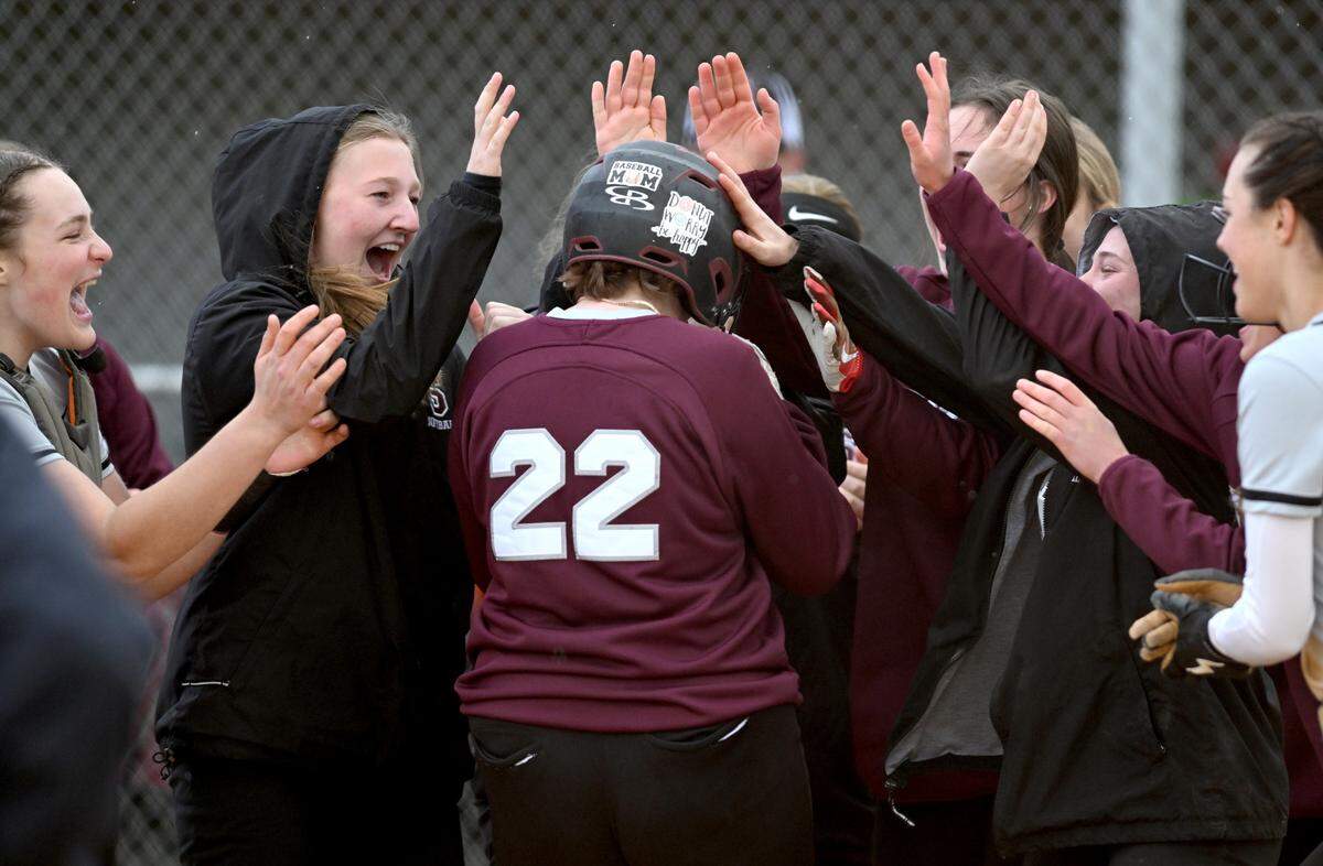 State College’s Meredith Meengs is congratulated by teammates after her homer in the second inning of the game against Mifflin County on Monday, April 24, 2023.