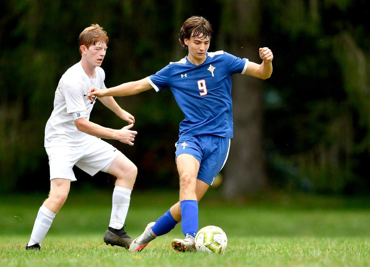 Saint Joseph's Spencer Gigante kicks the ball ahead of a Philipsburg-Osceola defender during the game on Thursday, Sept. 16, 2021.  