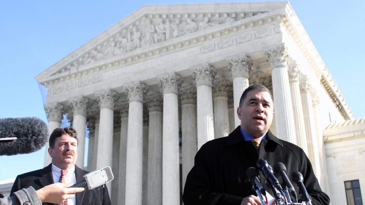 Citizens United President David Bossie (right) meets with reporters outside the U.S. Supreme Court.