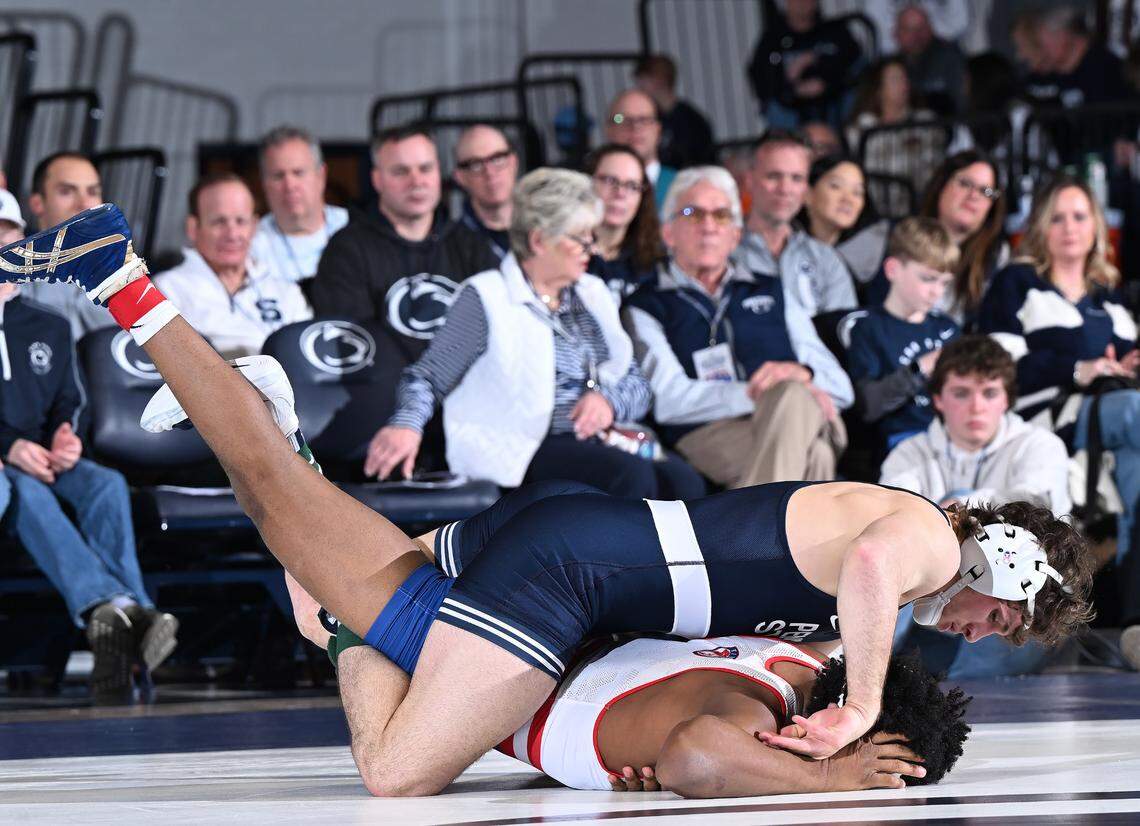 Penn State’s Levi Haines (top) racks up riding time against American’s Caleb Campos at 174 lbs during Friday’s match at Rec. Hall in State College. Haines defeated Campos by a pin-fall. Penn State defeated American University, 50-3. (For the CDT/Steve Manuel)