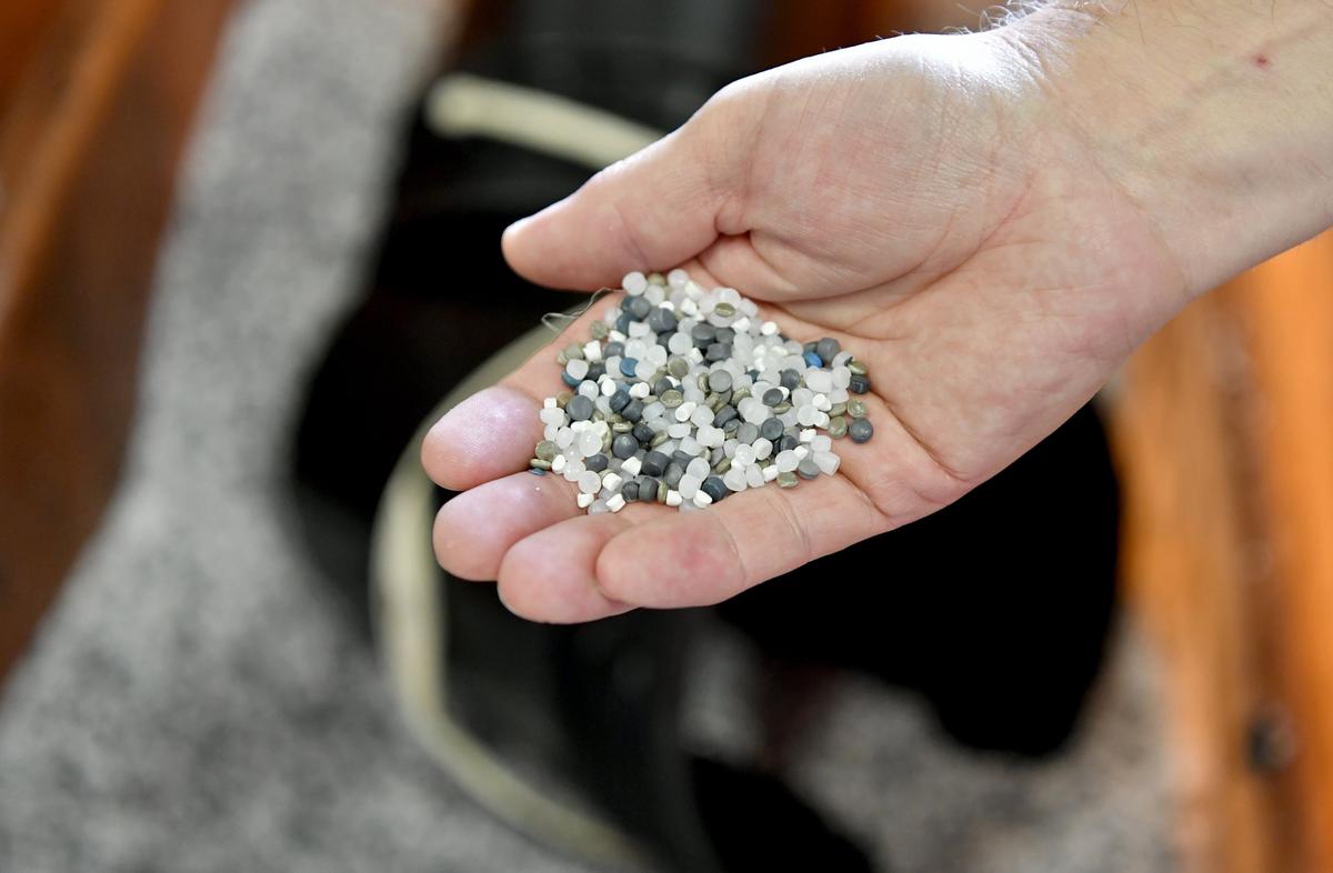Plant manager Bill Zajac holds a handful of recycled plastic pellets that will be used to make new bags at Hilex Poly on Wednesday. Hilex Poly is a plastic bag plant owned by Novolex.
