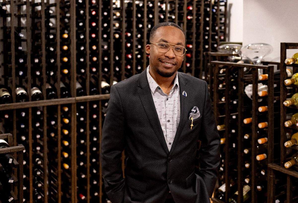 Richie Woodham stands among the wines available at Lionne and 1855 Lounge in the Nittany Lion Inn on Thursday, Feb. 20, 2025.