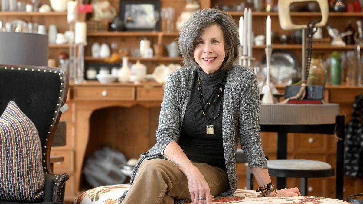 Patricia Gordon sits among pieces for sale in her shop Riley on Main on Monday, March 20, 2023.