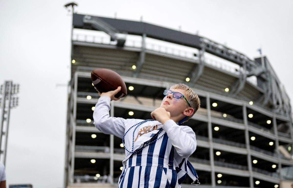 Kaiden Dare, 7, plays catch outside of Beaver Stadium before the Penn State game against Illinois on Saturday, Sept. 28, 2024.