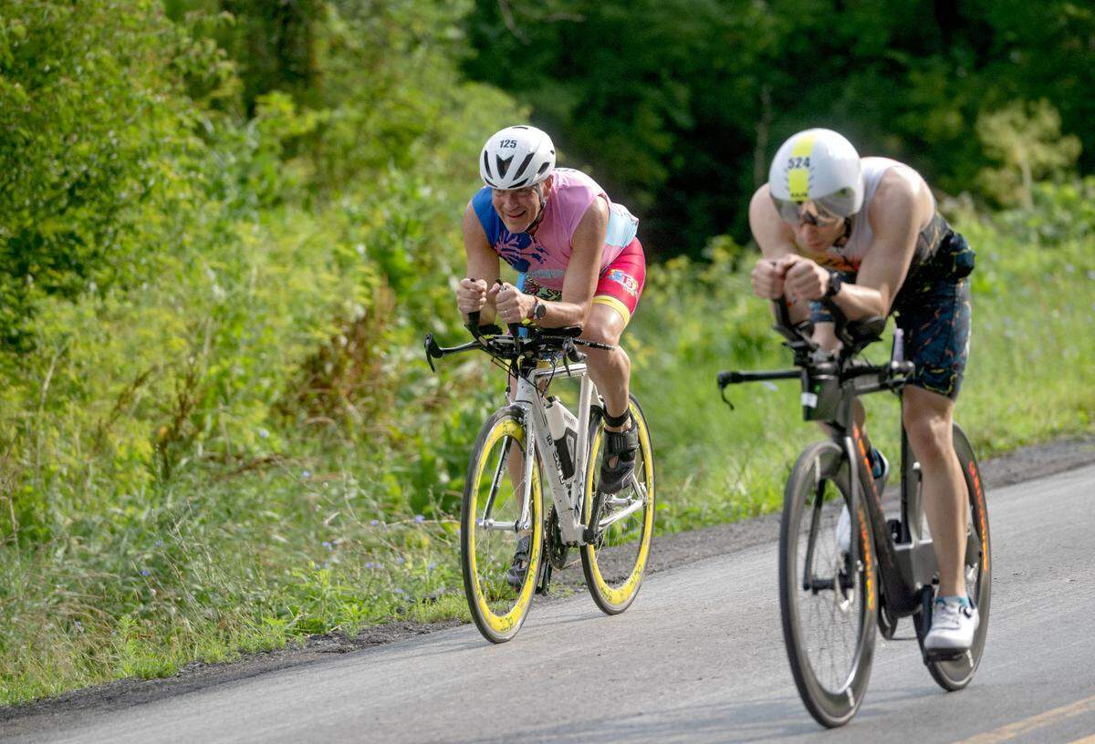 Cyclists cruise along Jacksonville Road as part of the 56 mile ride in the Ironman 70.3 Pennsylvania Happy Valley on Sunday, June 30, 2024.