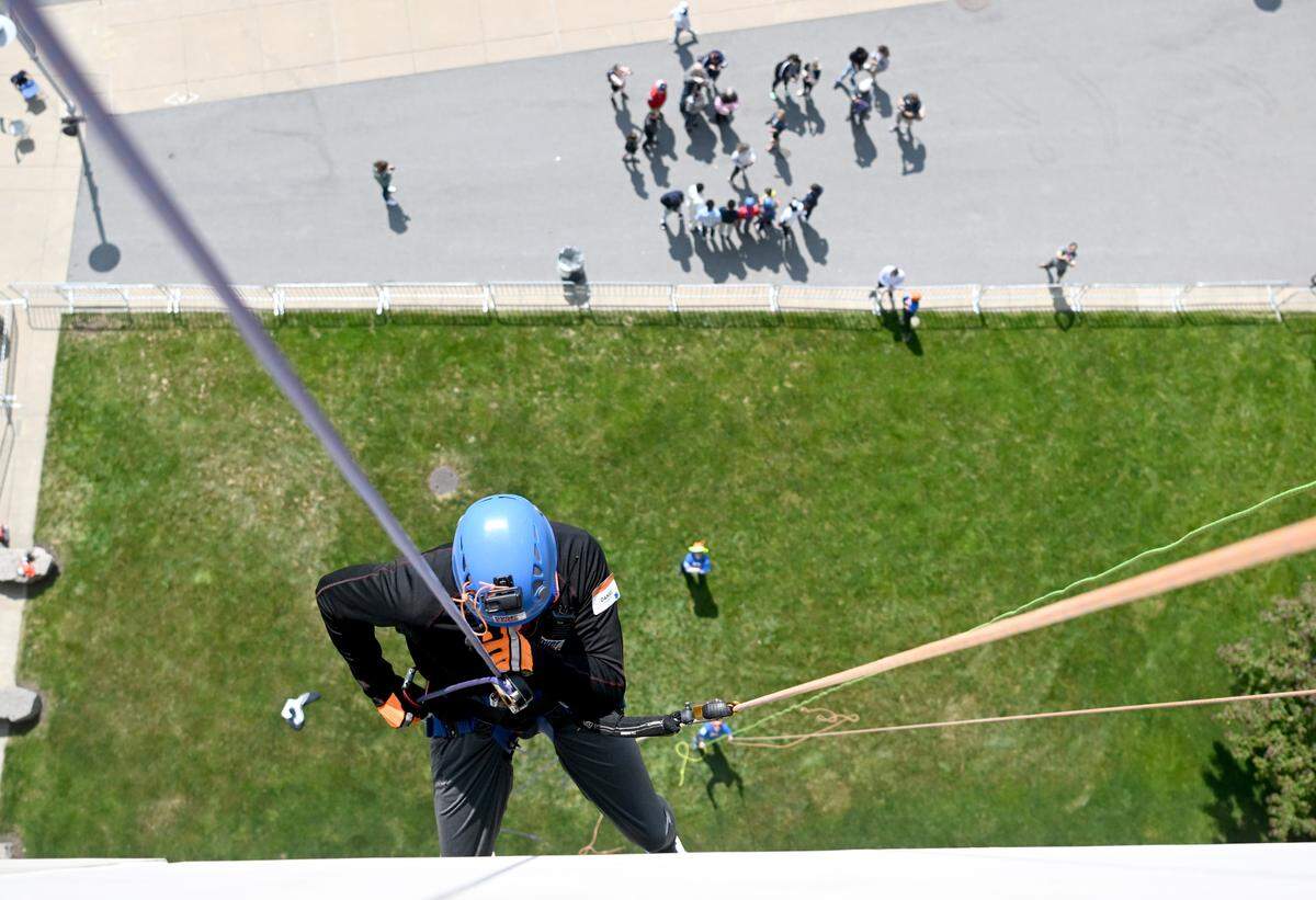 Daniel Morrow rappels down the side of Beaver Stadium for the Centre County United Way Over the Edge fundraiser on Friday, May 19, 2023.