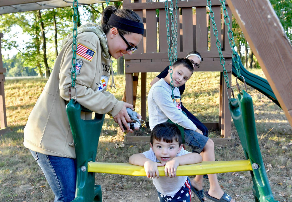 Megan Marko laughs with stepbrother Isaiah, 3, as he plays on the swing set at Randi Twoey’s house on Thursday, Aug. 20, 2020. Megan and her twin sister, Morgan, have become close friends with Randi as she is organizing a benefit concert for them.