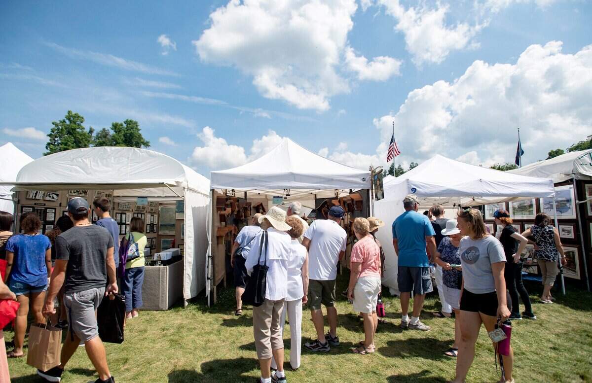 Patrons browse the artist booths at the People’s Choice Festival on Friday, July 13, 2018.