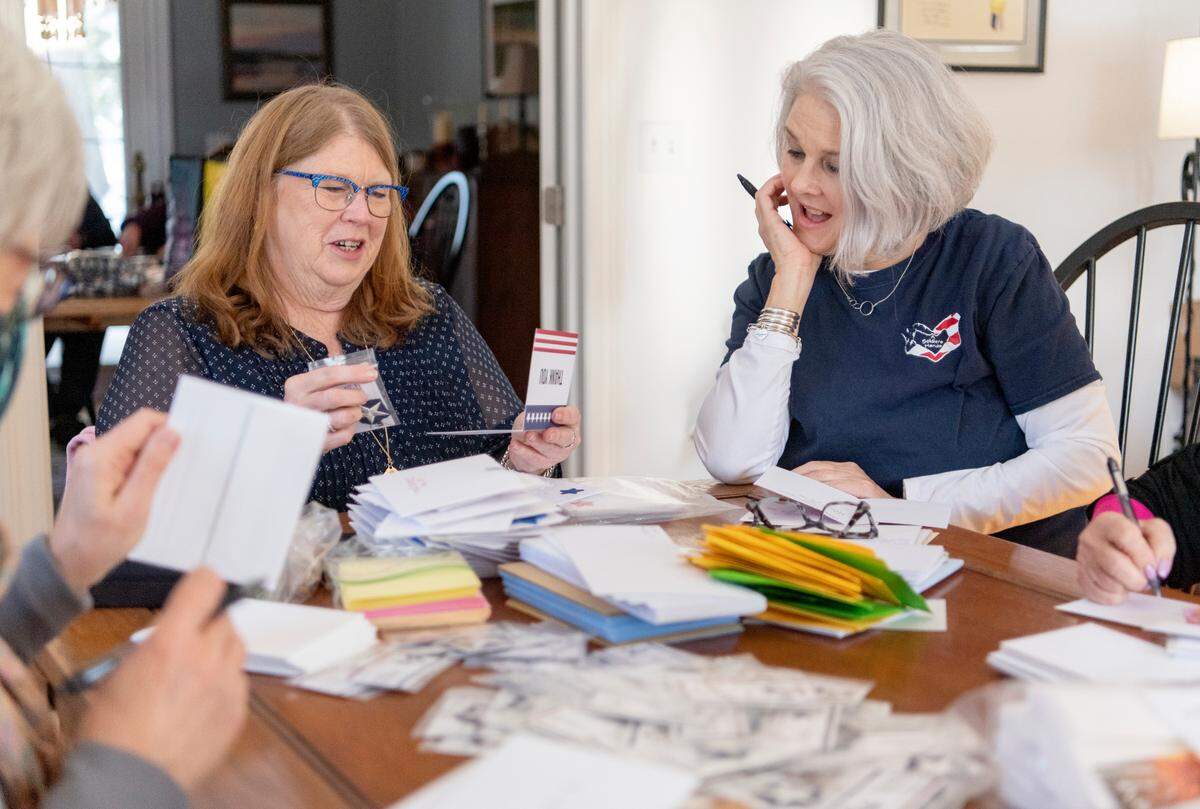 Pam Meyer and Trish Shallenberger admire a card that will be sent to deployed military members through A Soldier’s Hands.