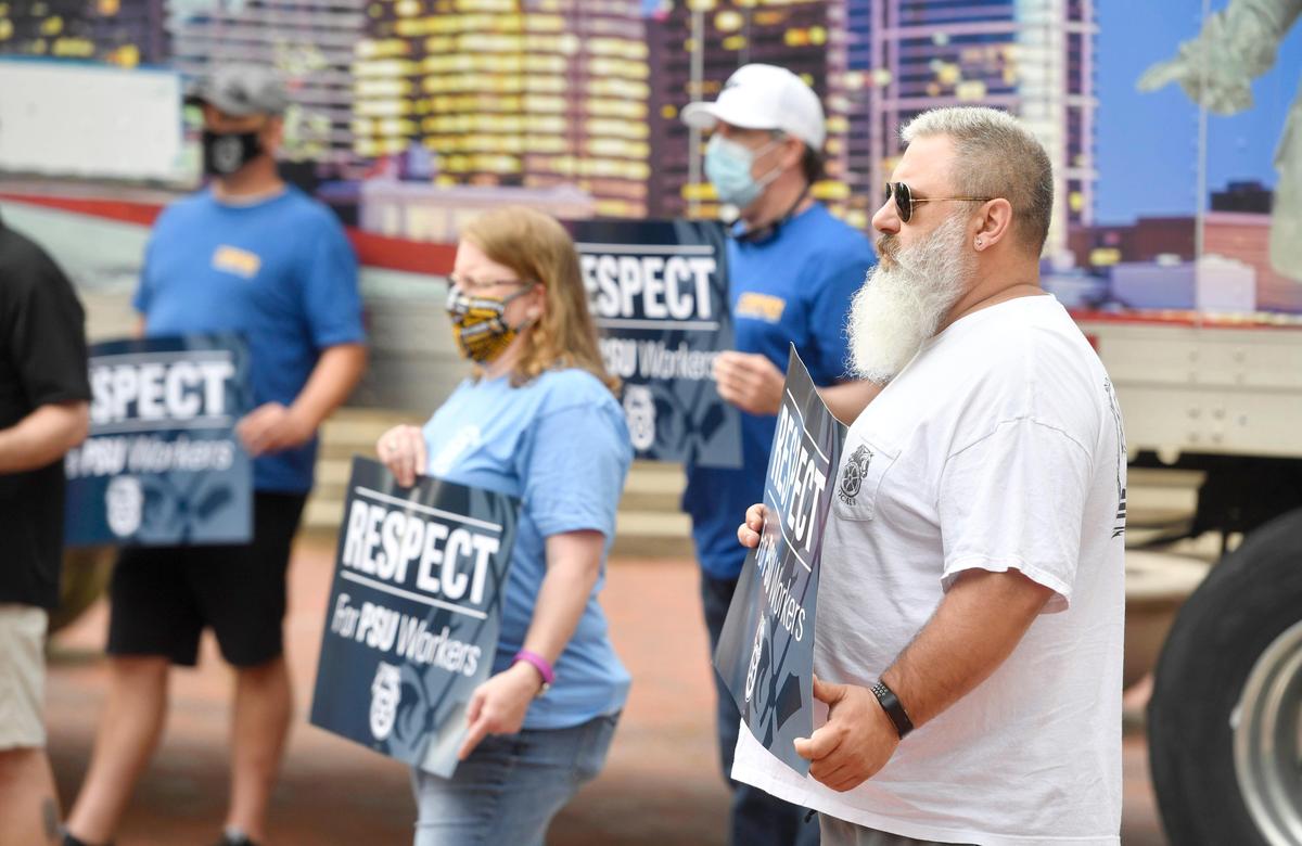 Jef Nelson and fellow Penn State employees who are are part of Teamsters Local 8 rally outside of the HUB on the Penn State campus on Wednesday, May 27, 2020.