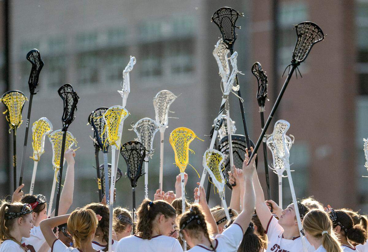 State College girls lacrosse team raises their sticks for a cheer before the second half of the game against CD East on Thursday, April 20, 2023.