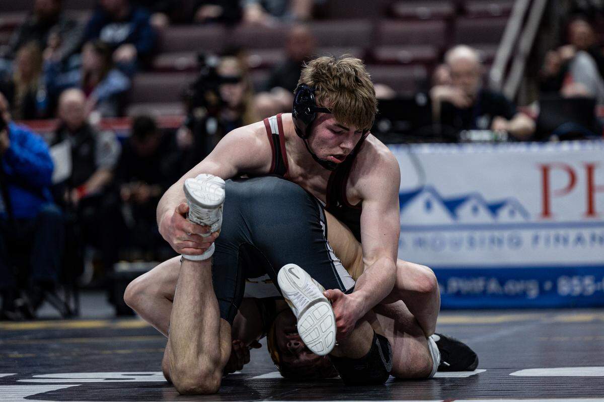 State College senior Asher Cunningham wrestles against Thomas Jefferson’s Bode Marlow on Saturday at Hershey’s Giant Center for the individual Class 3A state title at 172 pounds. Cunningham won by 12-6 decision to collect his second straight state title.