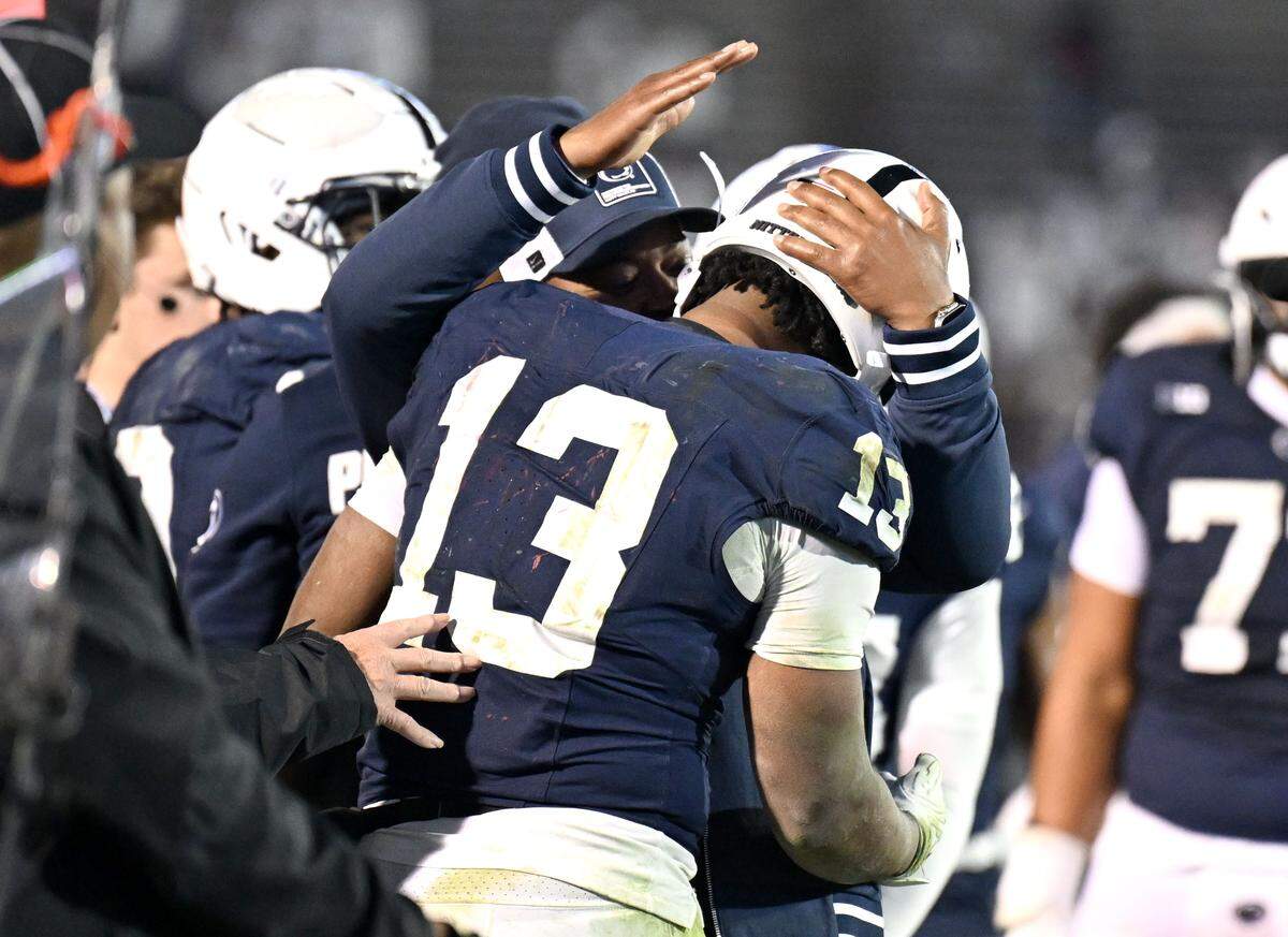 Penn State interim coach Terry Smith congratulates  running back Kaytron Allen after he broke the career rushing record on Saturday, Nov. 22, 2025 at Beaver Stadium.  