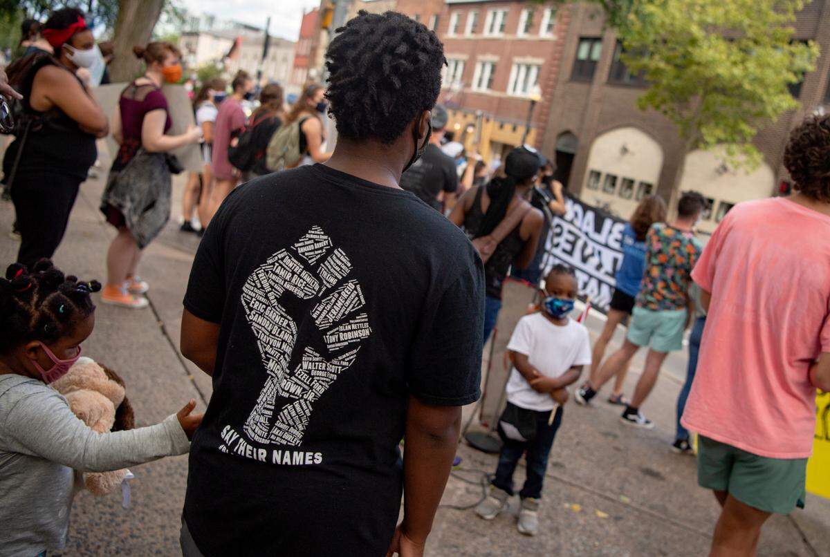A crowd gathers at the Allen Street gates for the march and teach in organized by the 3/20 Coalition on Saturday, Aug. 29, 2020.