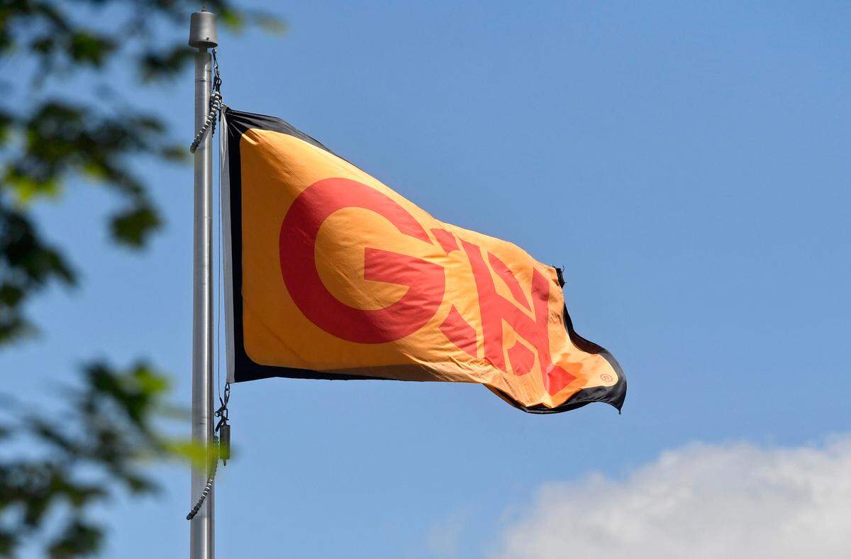 A flag with the Glenn O. Hawbaker logo waves in the wind outside of their office building in Patton Township.