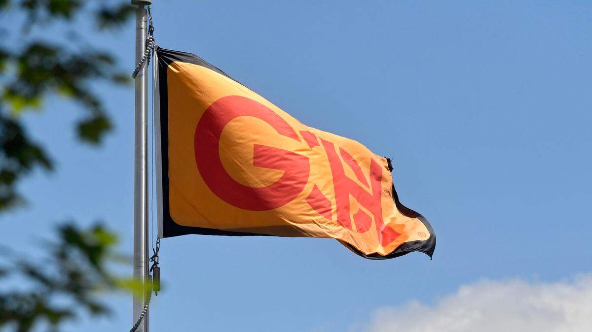 A flag with the Glenn O. Hawbaker logo waves in the wind outside of their office building in Patton Township.