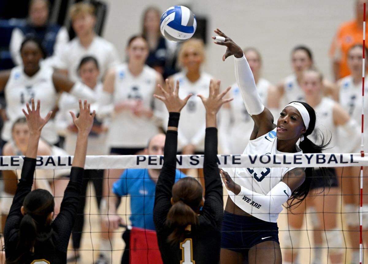 Penn State’s Kashauna Williams hits the ball over UMBC defenders during the game in the first round of the NCAA tournament on Friday, Dec. 2, 2022 in Rec Hall.