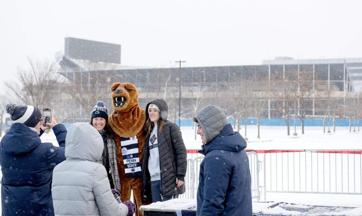 Penn State fans pose with the Nittany Lion after the press box at Beaver Stadium was brought down on Saturday, Jan. 4, 2025.