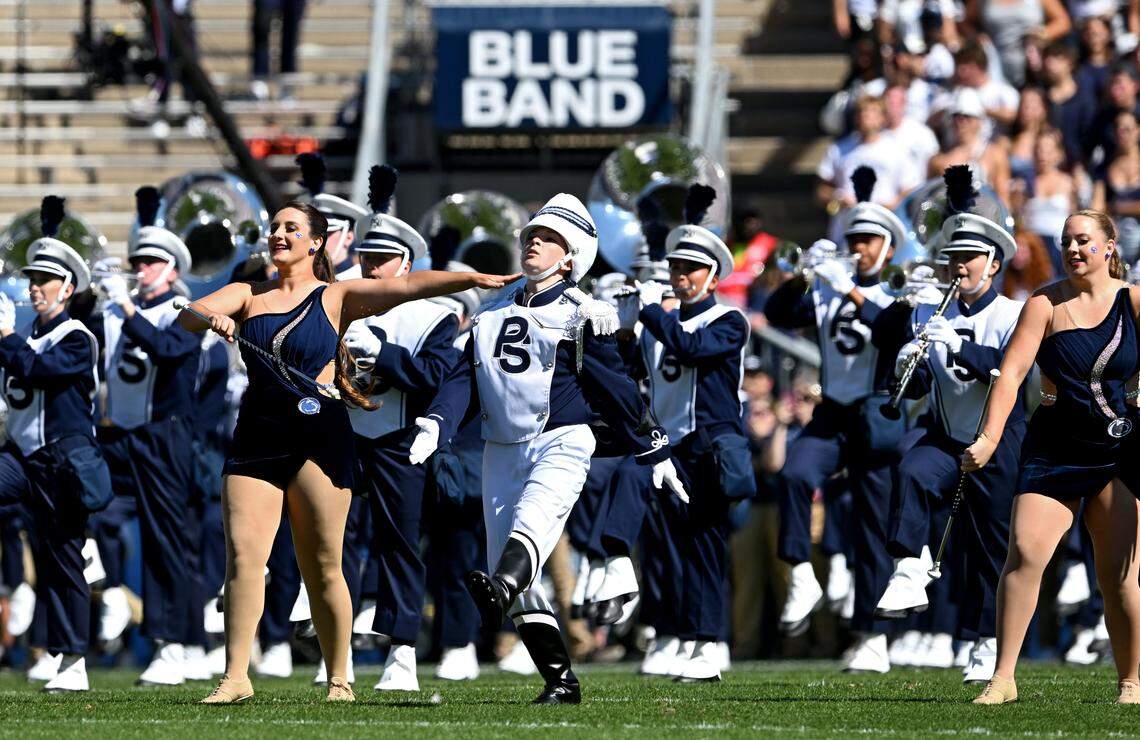 Penn State Blue Band drum major Ellie Sheehan runs through the band to do the first flip of the pregame show on Saturday, Aug. 30, 2025.  