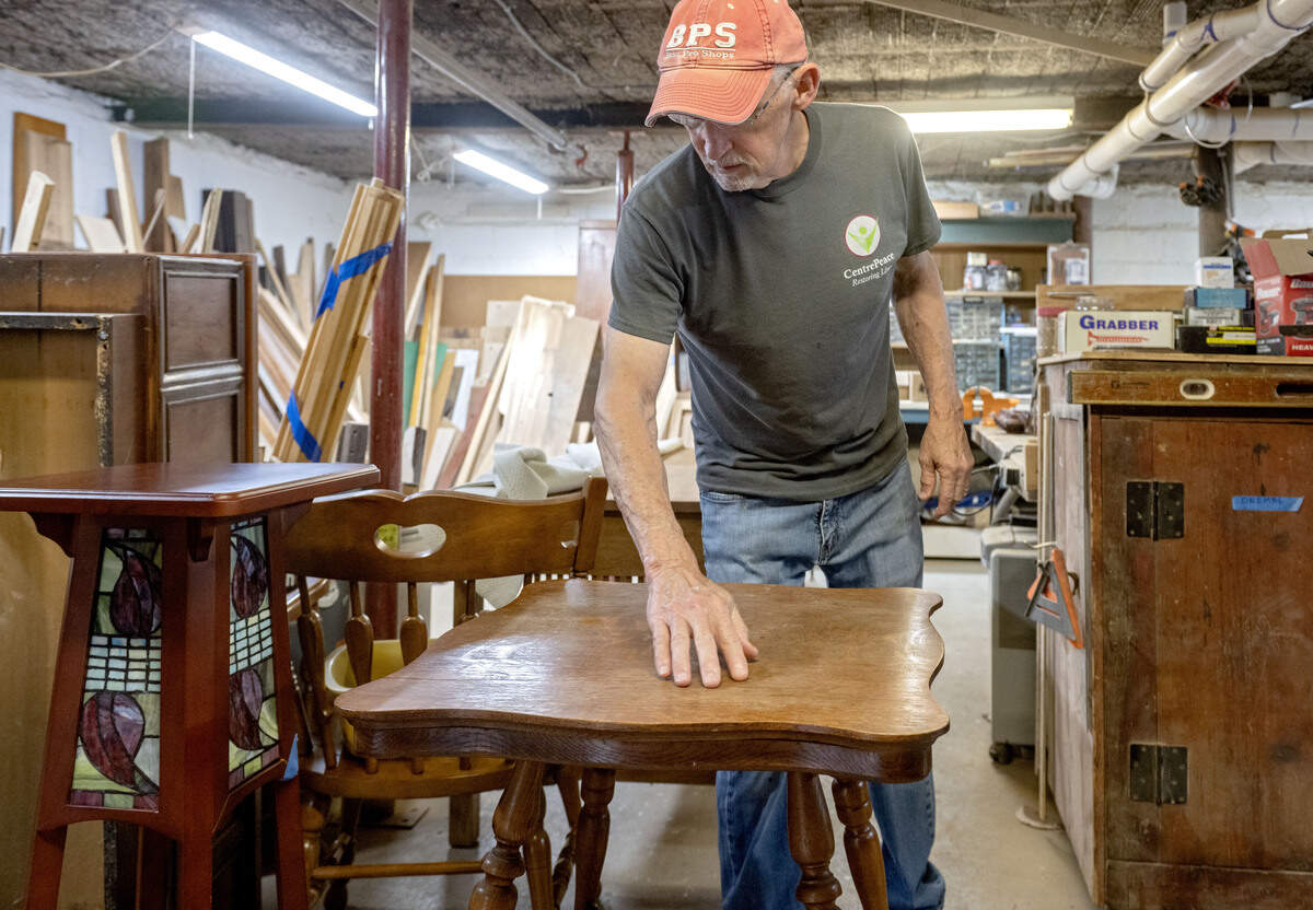 Bob Shoemaker looks over a tables that was donated to CentrePeace on Tuesday, June 23, 2026. Shoemaker volunteers in the repair shop.