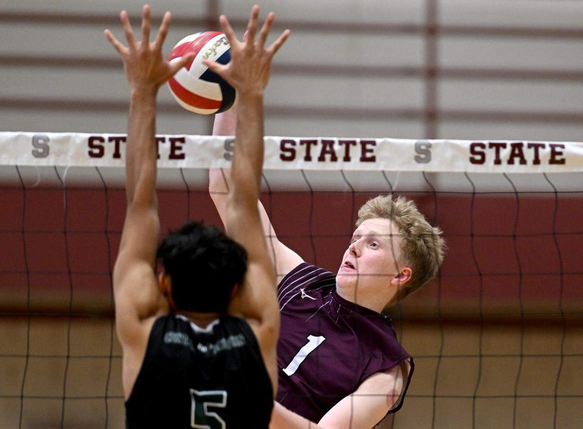 State College’s Kieran Leahey hits the ball past a Central Dauphin defender during the boys volleyball game on Wednesday, May 10, 2023.
