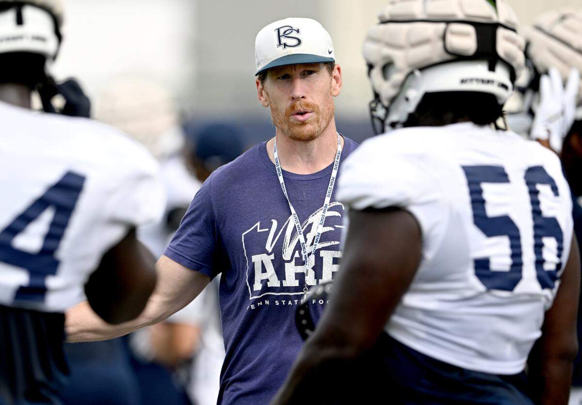 Penn State offensive line coach Phil Trautwein talks to players as they run a drill at practice on Wednesday, Aug. 30, 2023.  
