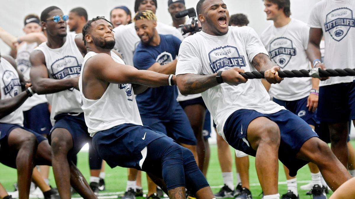 Penn State linebacker Micah Parsons yells as he and the defense try to beat the offense in tug-of-war during the annual Uplifting Athletes’ Lift for Life on Friday, July 12, 2019 at Holuba Hall.