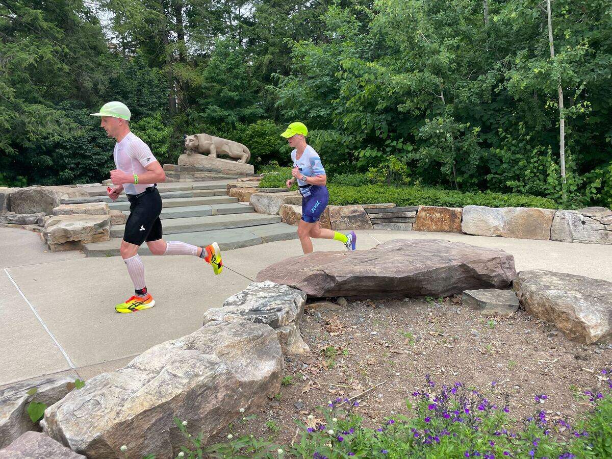 Two participants run past the Nittany Lion statue on Penn State’s campus Sunday, June 14, 2026, at the Ironman 70.3 Pennsylvania Happy Valley North American Championship in Centre and Clinton counties.