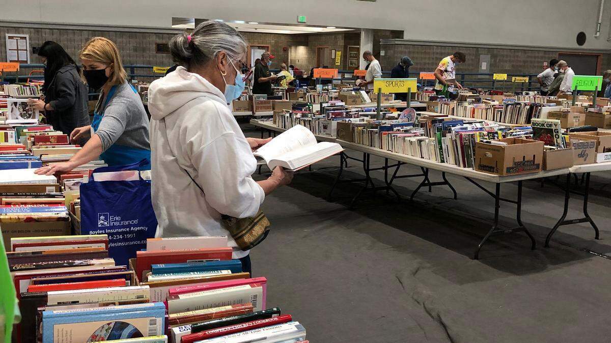 A shopper at the October AAUW Used Book Sale in State College takes time to look through one of the books.