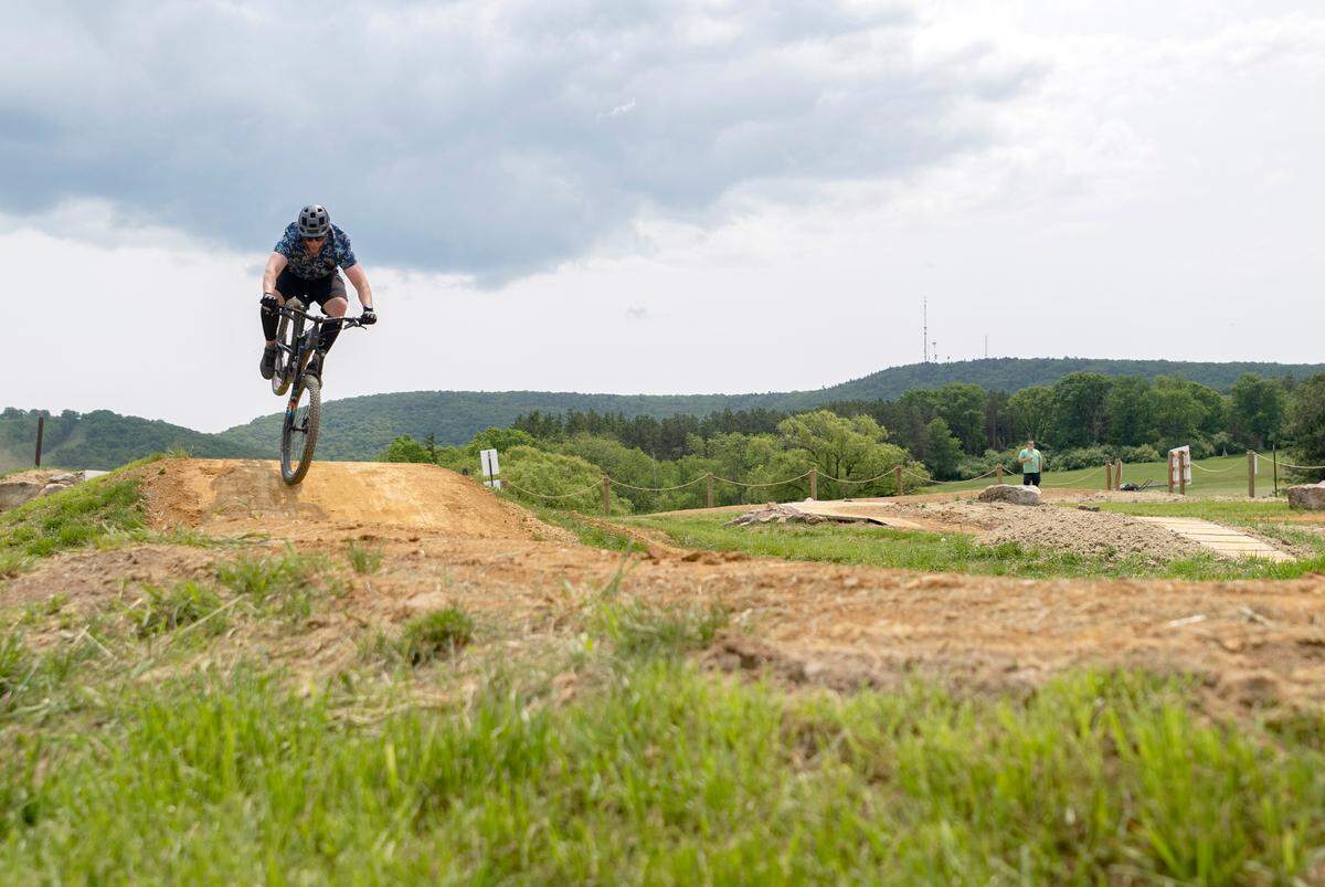 Seth Maurer bikes at the Harvest Fields community trails new skills park on Monday, May 22, 2023.