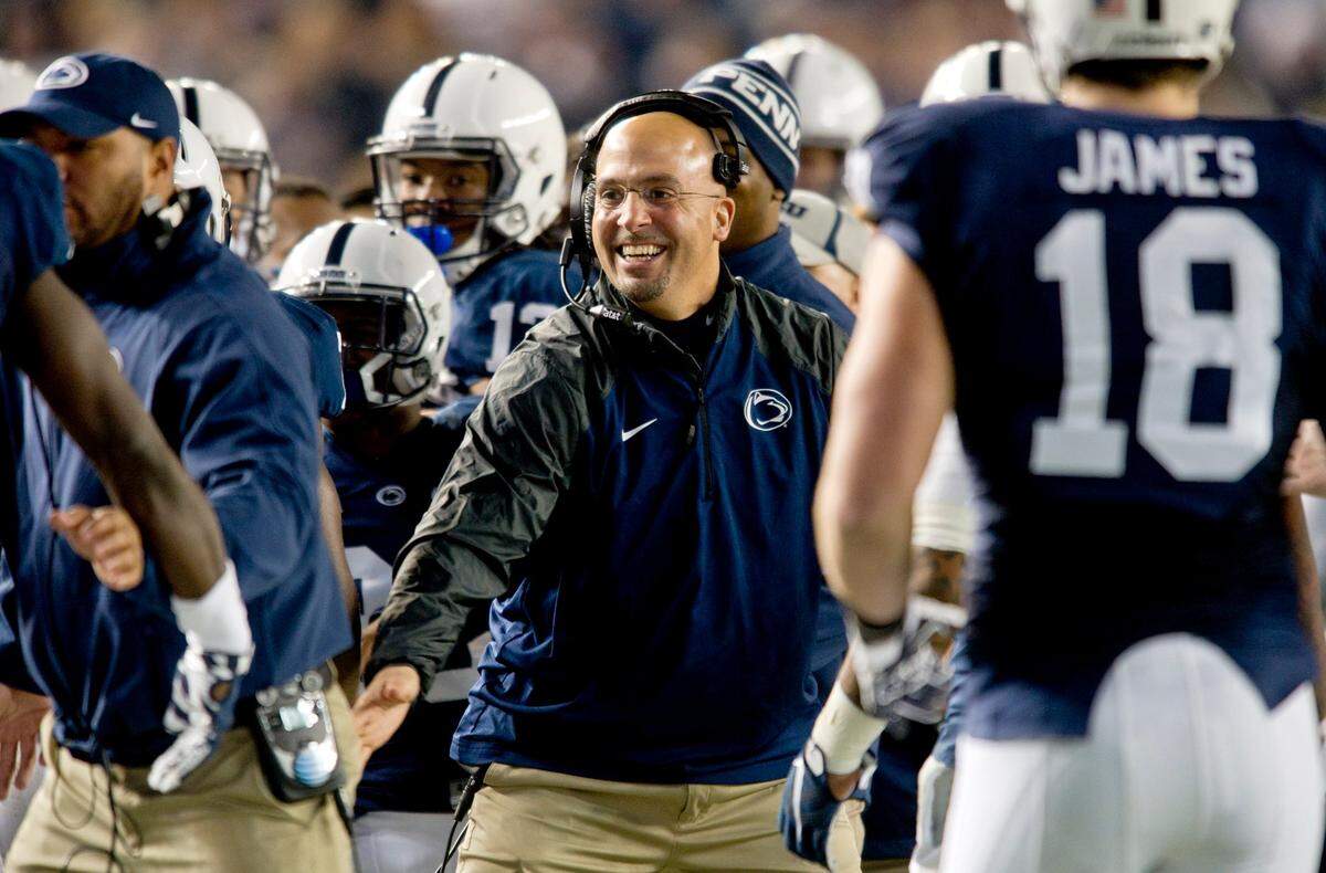 Penn State football coach James Franklin high-fives players after a touchdown during the Saturday, December 27, 2014 Pinstripe Bowl game against Boston College at Yankee Stadium. Penn State won in overtime, 31-30.