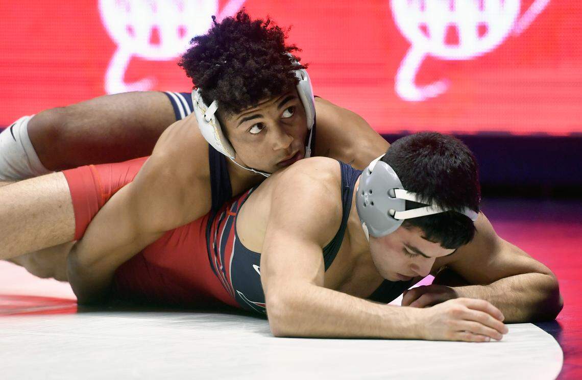 Penn State’s Roman Bravo-Young looks to the time clock as he controls Penn’s Carmen Ferrante in the 133 lb bout during the match on Sunday, Dec. 8, 2019. Bravo-Young won by major decision, 21-9.
