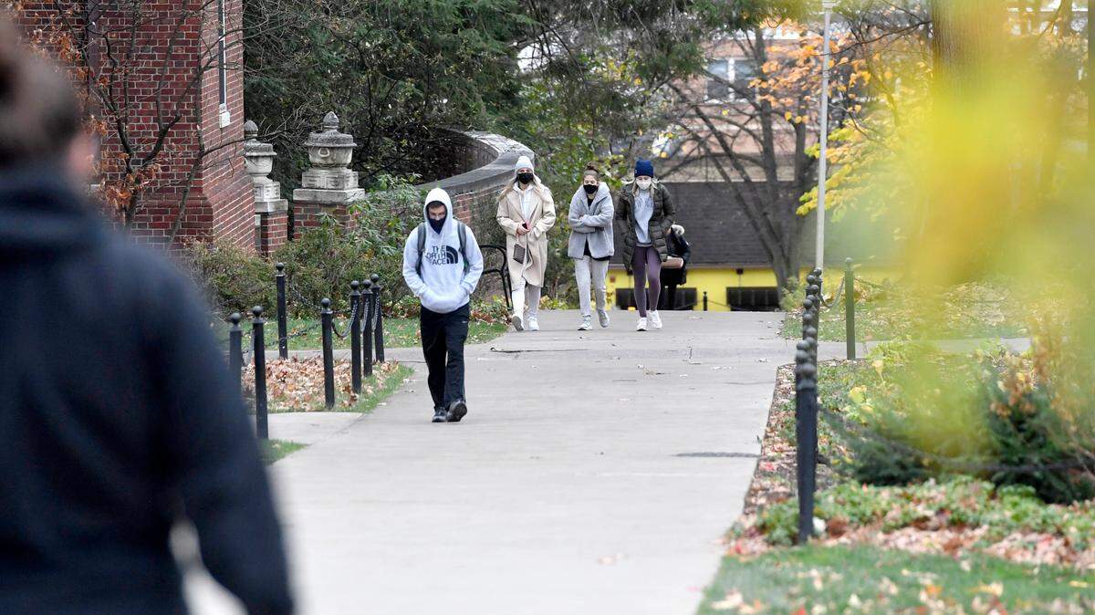 Penn State students walk through campus wearing masks in November 2020.