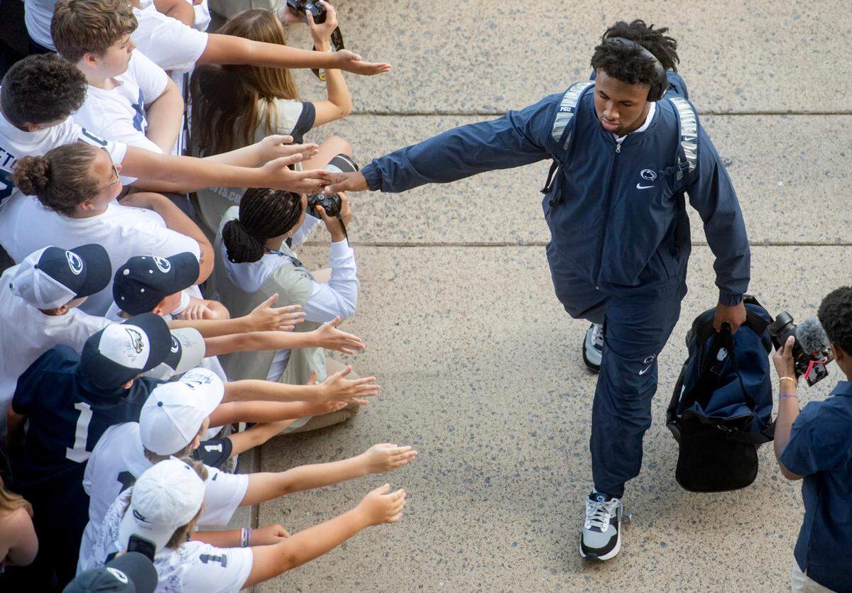Penn State running back Nick Singleton high fives fans as he and the team arrive at Beaver Stadium for the game against West Virginia on Saturday, Sept. 2, 2023.