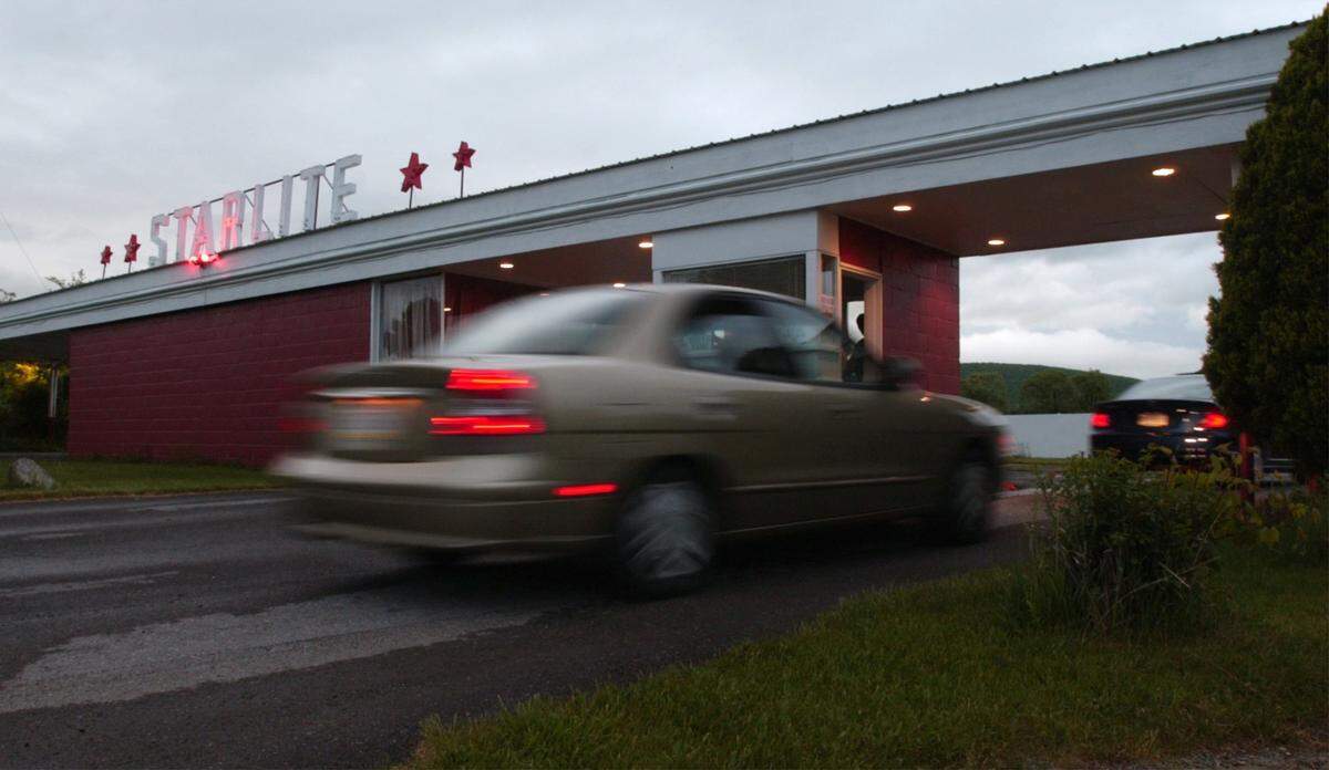 Cars enter the Starlite Drive-In Theatre Saturday night, May 15, 2004.