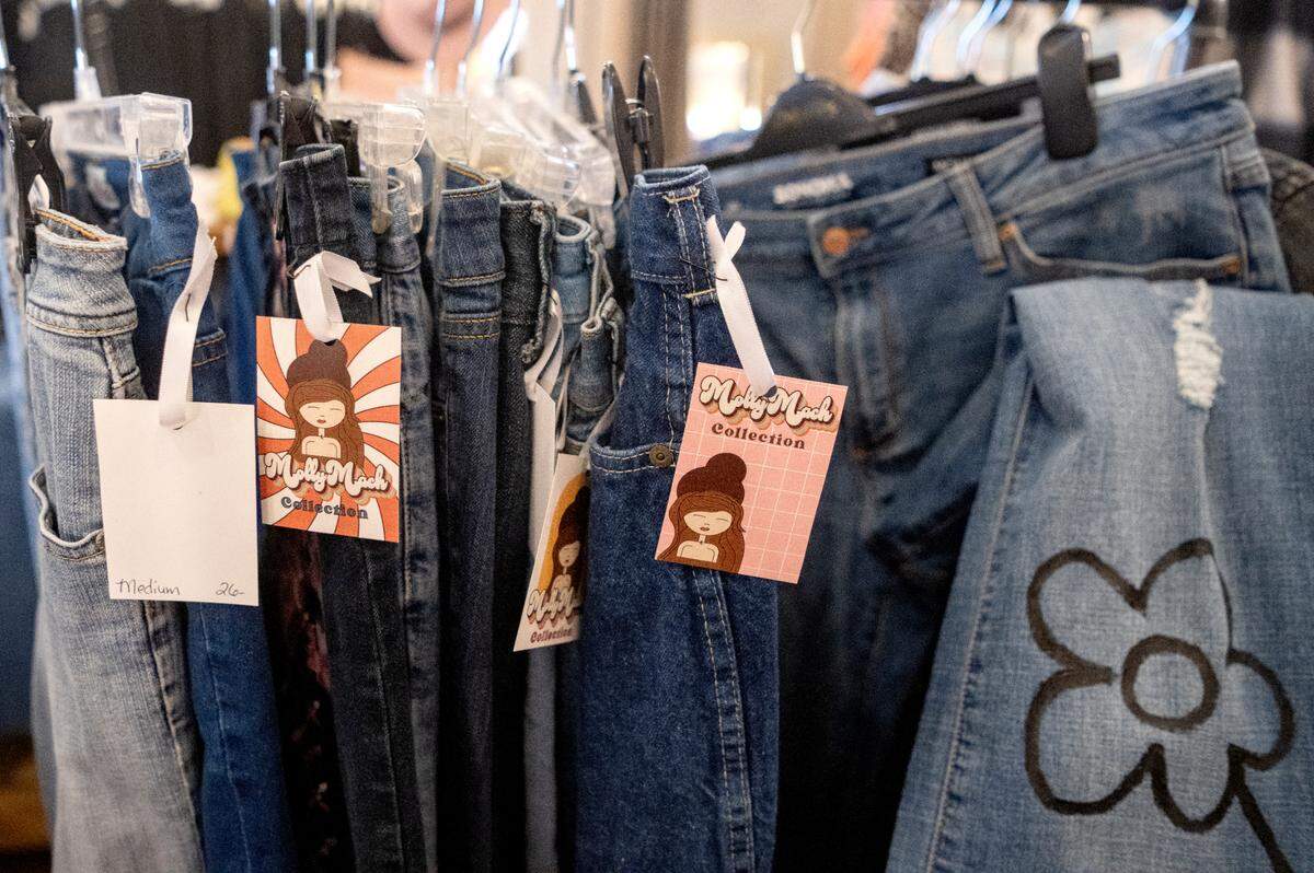 Up-cylced jeans that are part of the Molly Mach Collection on display at Helen Foxx & Co. for Molly Marciano’s pop up shop on Saturday, July 22, 2023. Helen Foxx & Co. owner Joyce Mills along with The Common Thread owner Jenni Bamer and several other Bellefonte artists helped Marciano make her dream of being a fashion designer come true.