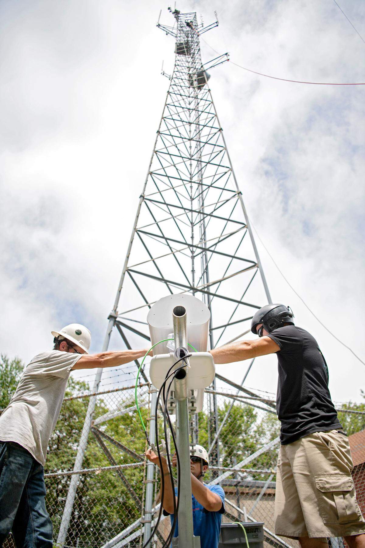 A crew from Centre Communications and Mains Technology Solutions help Centre WISP Venture Company install two sector antennas on a tower on Centre Hall Mountain on Wednesday. The two antennas installed will have a 180 degree coverage area of the valley.