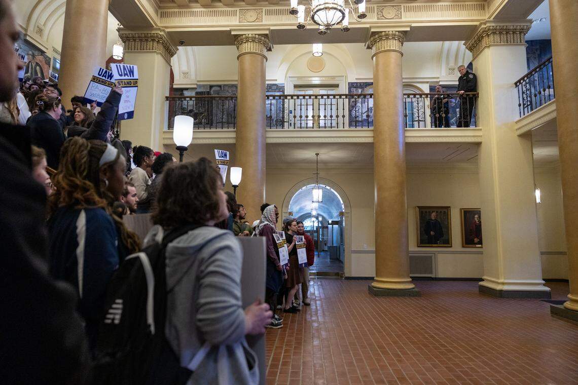 Graduate students chant inside Old Main during a rally on Tuesday, April 21, 2026