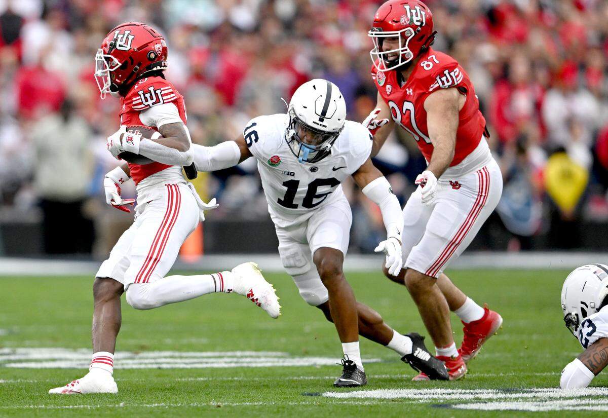 Penn State safety Ji’Ayir Brown reaches for Utah’s Money Parks during the Rose Bowl game on Monday, Jan. 2, 2023.