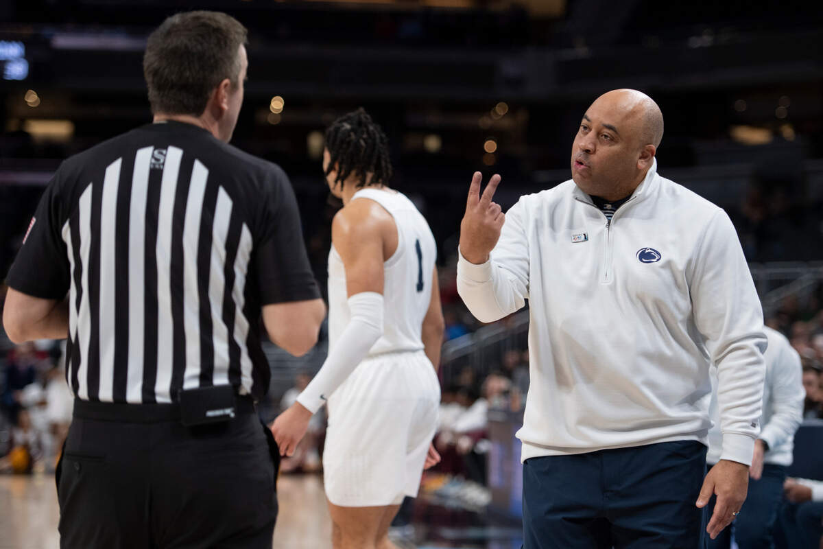 Penn State head coach Micah Shrewsberry speaks to the referee during a time out at the Big Ten basketball tournament game between Penn State and Minnesota at Gainbridge Fieldhouse on Wednesday, March 9, 2022 in Indianapolis, Ind.